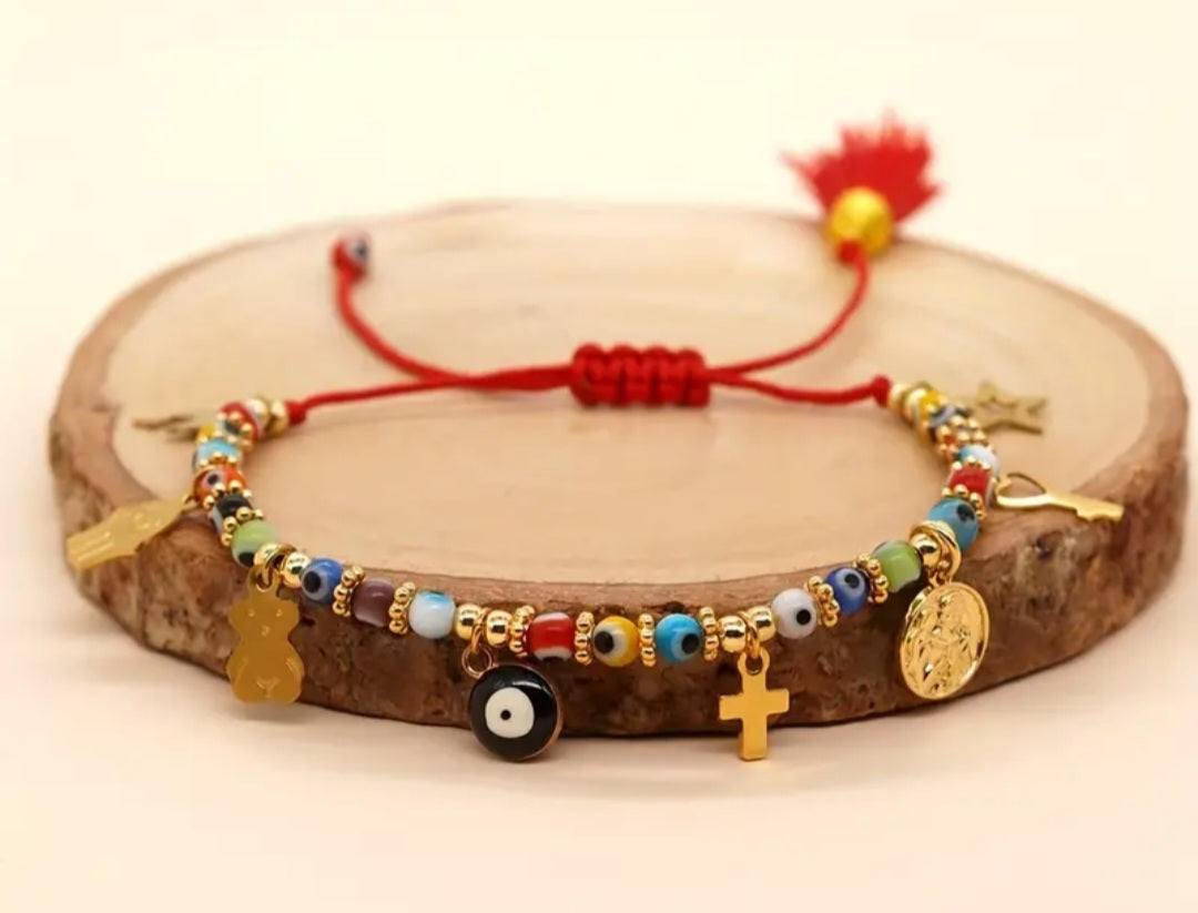 Pulsera protección hilo rojo con ojo turco y varios dijes/ Red thread protection bracelet with Turkish evil eye and various charms.