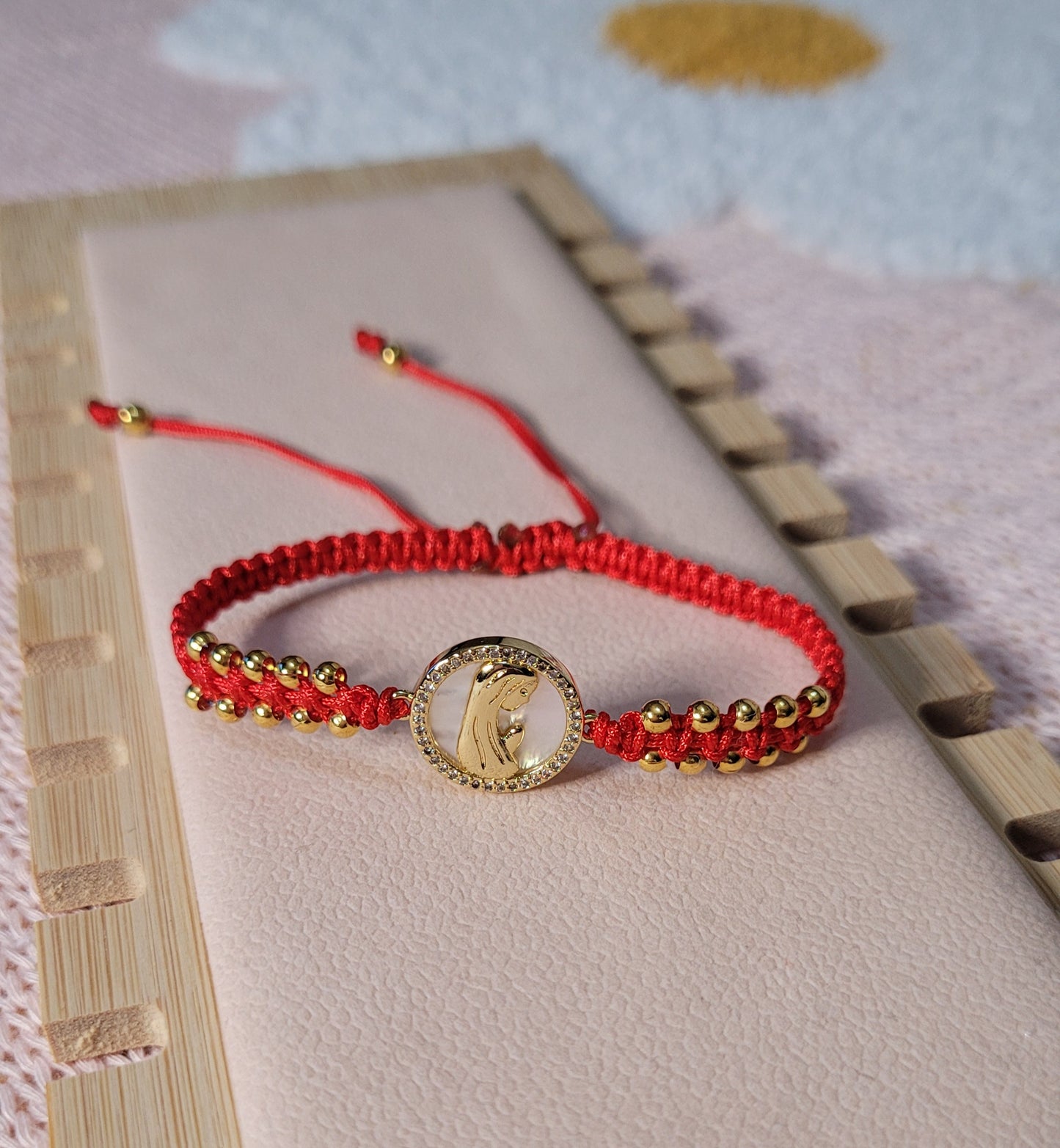 Pulsera tejida ajustable con cuentas y charm de Virgen María con nácar/Adjustable woven bracelet with beads and Virgin Mary charm with mother-of-pearl